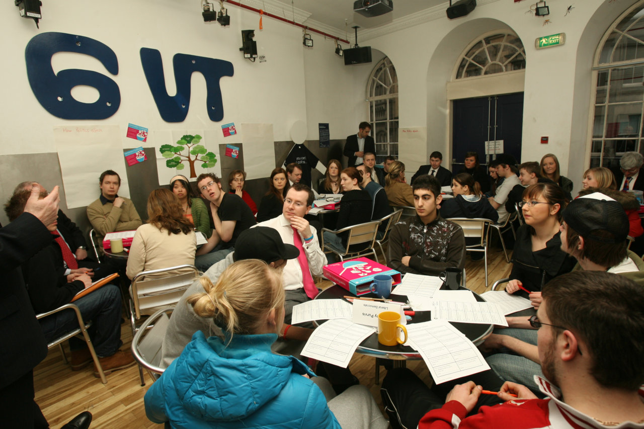 Groups of people meeting around tables