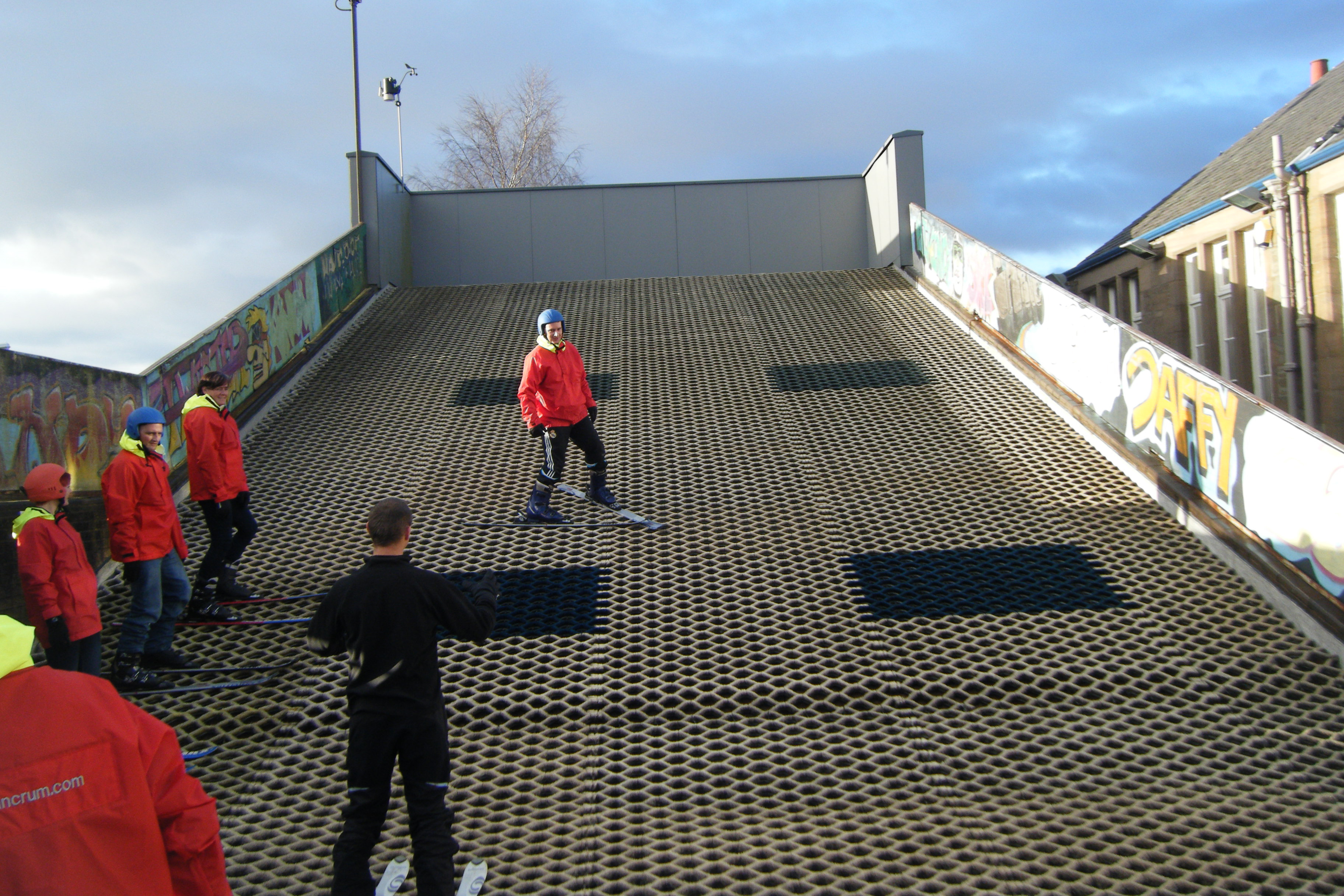 A group of people in a dry ski slope