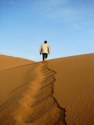 A person walking in the sand